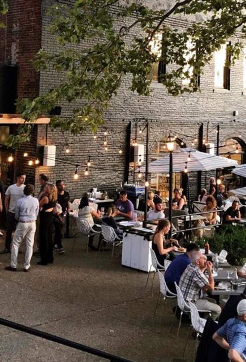 People eating on the patio of Plant City in Providence, RI.
