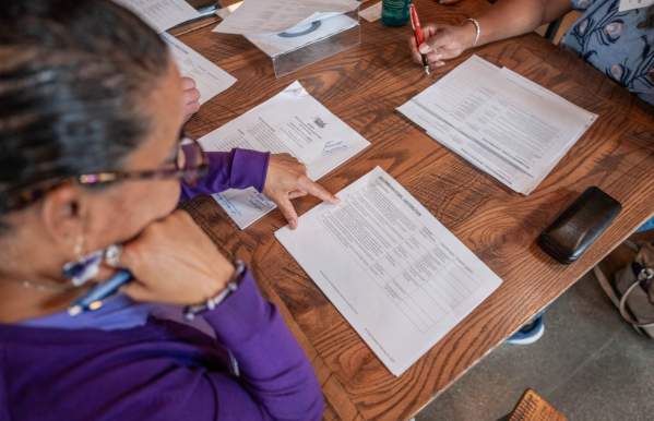 A woman reviewing a strategy document on a table.